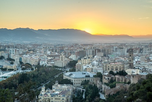 Sunset over Malaga skyline and mountains free photo