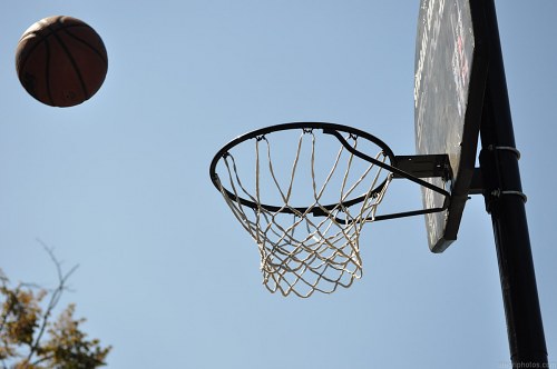 Basketball ball hitting the basket free photo